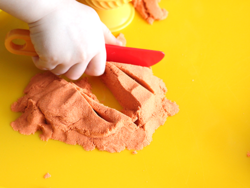 Cutting Kinetic Sand with knife