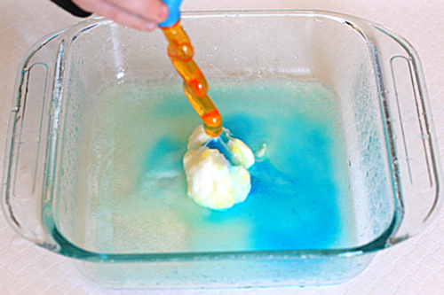 Squirt vinegar on baking soda egg and watch as surprise color appears!