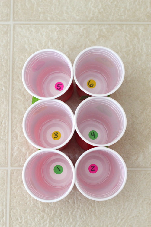 Put numbered dot stickers in the bottom of plastic cups