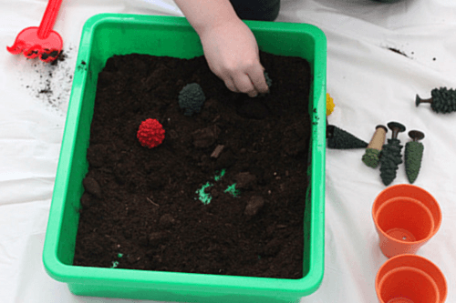 Dig in soil and pretend to plant tree toys