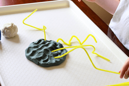 Bend yellow pipe cleaners so that they look like lightening bolts and insert them into the play dough