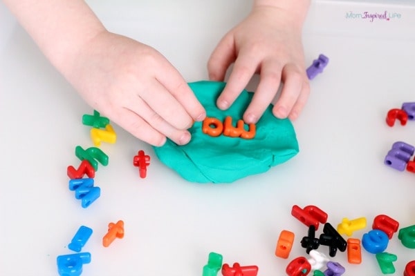 Stamping sight words in play dough. A hands-on literacy activity.