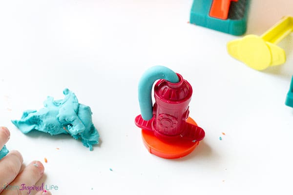 Using play dough toys to develop fine motor skills in preschoolers and toddlers.