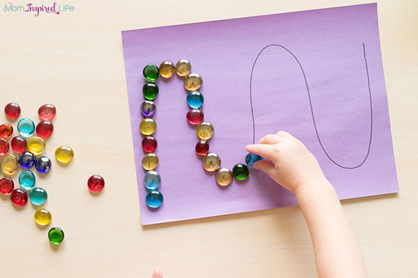 Tracing lines with buttons or gems fine motor activity for preschool.