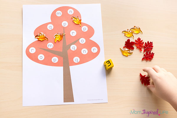 This fall tree roll and cover game is a fun way for kids to learn number sense and the alphabet this fall.