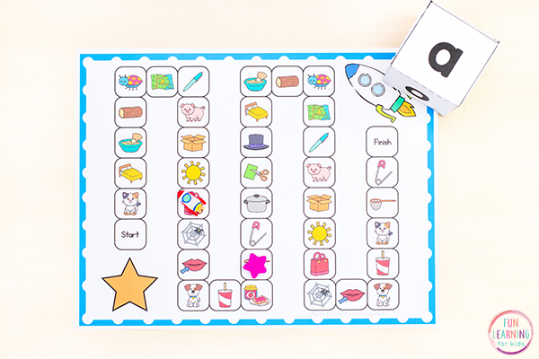 Free CVC middle vowel sounds printable board game for reading instruction in kindergarten or first grade.