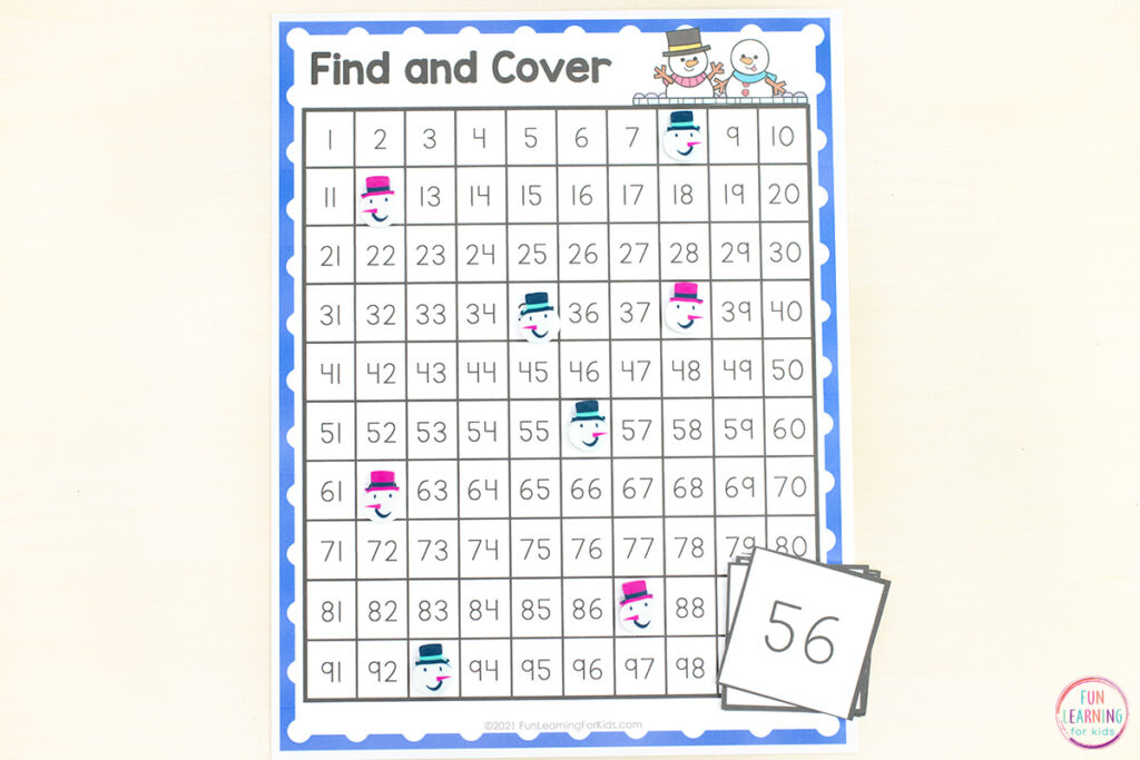 Develop number sense with this free snowman 100 chart math activity for kindergarten math centers.