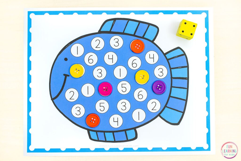 Roll and cover mats with a blue fish on it. Numbers are all over the fish and students roll one dice and cover the number on the fish with colorful buttons.