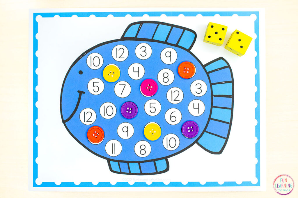 Ocean theme roll and cover addition math activity. Students roll two dice and then cover the corresponding number on the mat with a button.