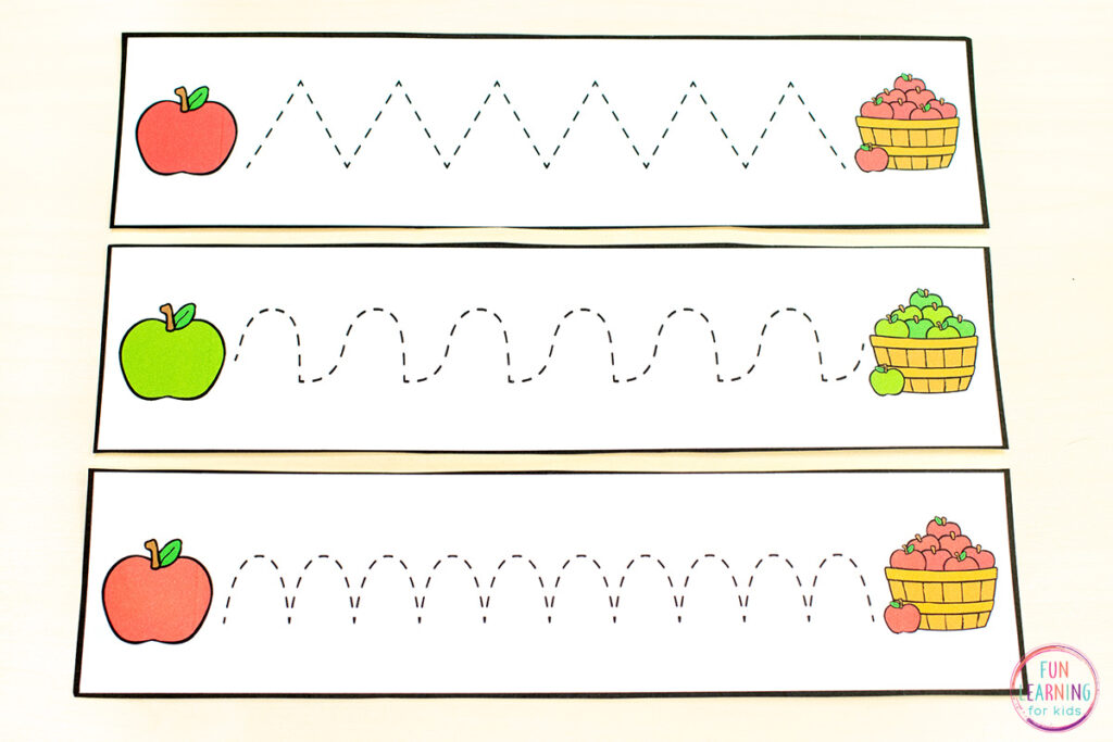 Free printable apple theme fine motor pre-writing tracing strips for kids in preschool.