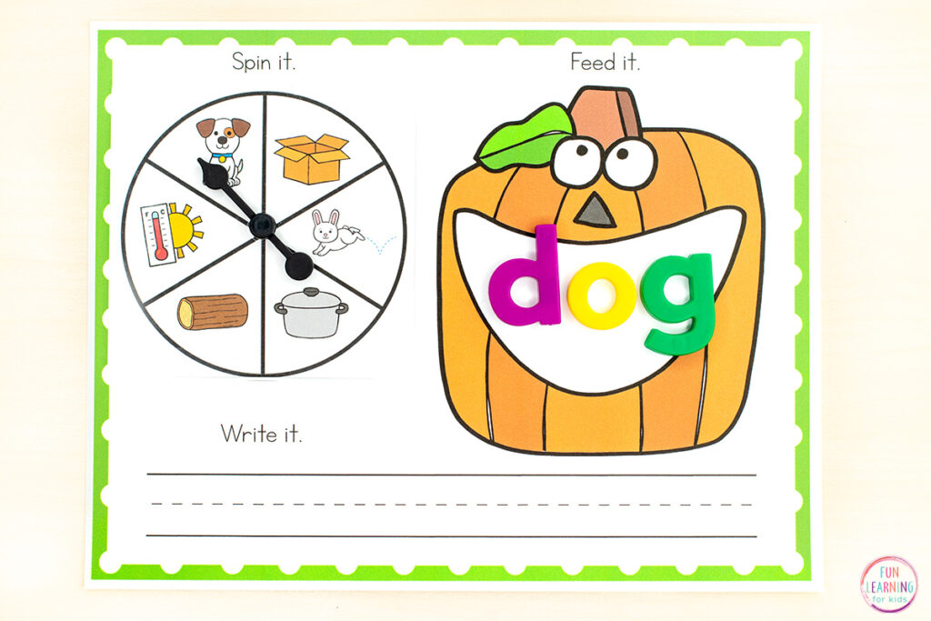 Pumpkin CVC word work printable mats for phonics instruction in kindergarten and first grade. Students spin the spinner on the top left, land on a CVC word picture, build the word in the pumpkin's open mouth on the top right and then write the word on the handwriting lines at the bottom of the mat.